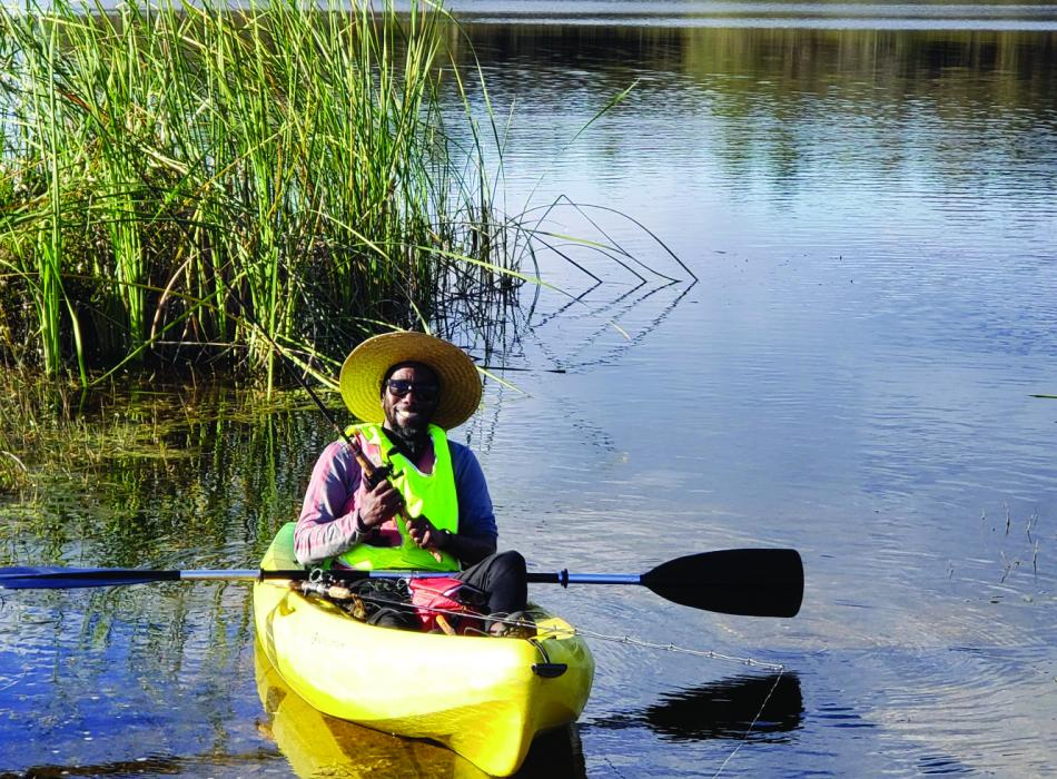 A man fishes while kayaking on the lake at Colt Creek State Park.